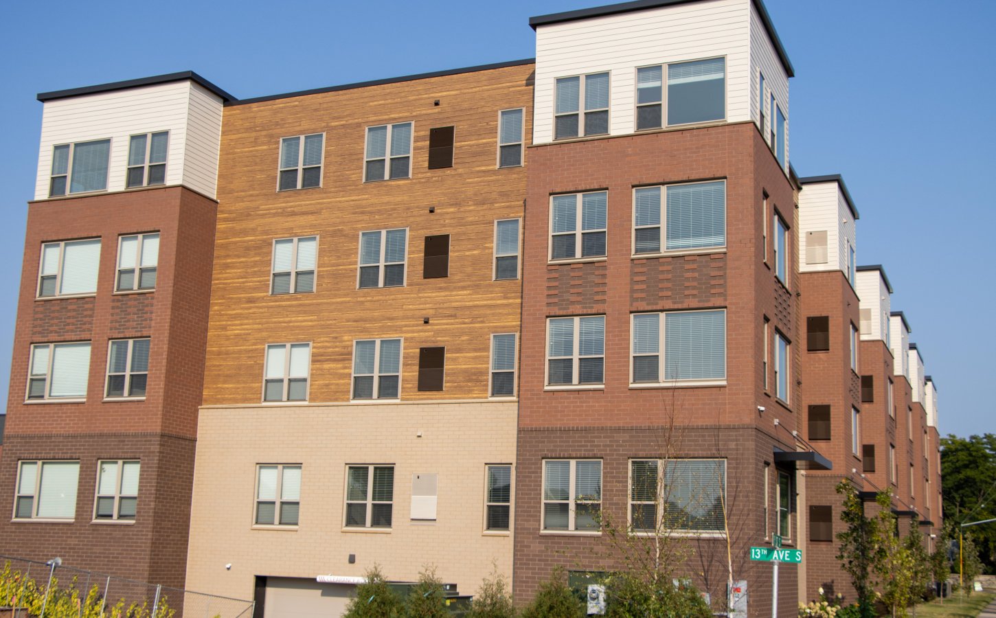 An exterior view of the side of an apartment building 