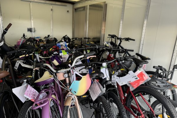 A trailer full of bicycles of different sizes and colors